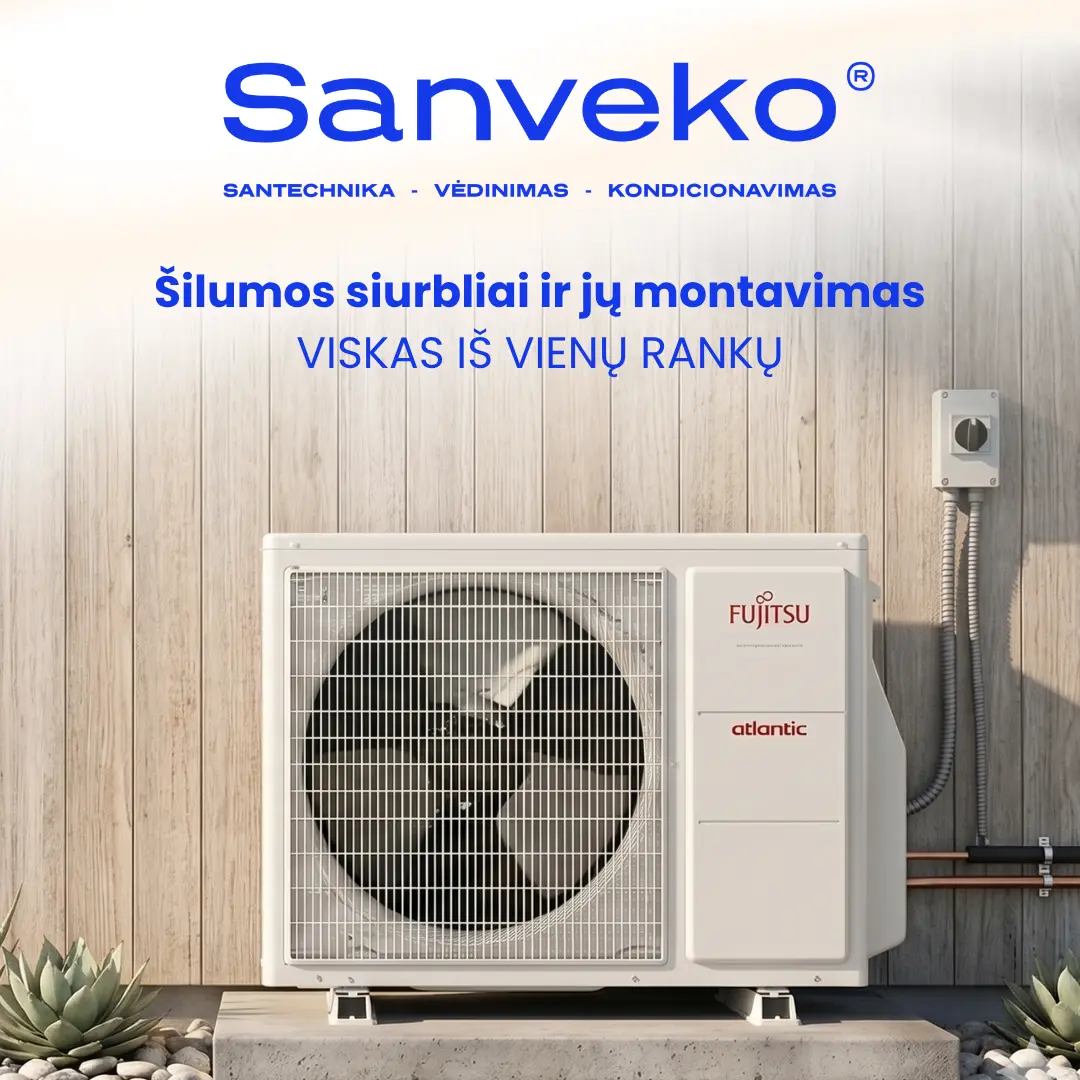 Outdoor heat pump unit mounted on a wooden wall, with brand labels Fujitsu/Atlantic and Lithuanian advertising text above it.